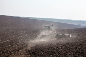 Harrowing the soil with disc harrows