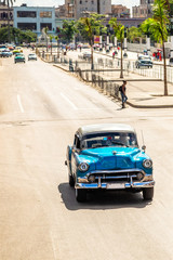 Old vintage blue retro car on the road in the center of Havana, Cuba