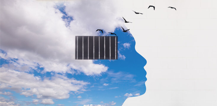 Free your mind concept and think out of the box concept, Panoramic blue sky with human head shape and security window bar in the head on the white wall with birds flying out from the window