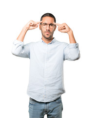 Serious young man doing a gesture of concentration