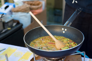 Chef preparing delicious organic pasta dish outdoor. Eating