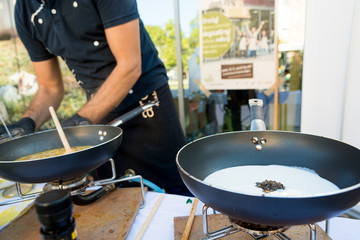 Chef preparing delicious organic pasta dish outdoor. Eating