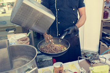 Chef preparing delicious organic pasta dish outdoor. Eating