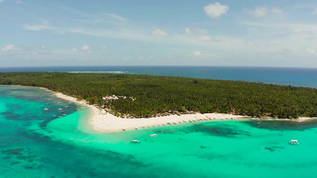 Seascape with a beautiful island. Daco island, Philippines. Tropical island with a white sandy beach for tourists. Island to relax.