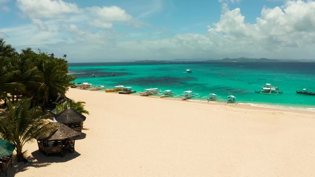 Seascape with a beautiful island. Daco island, Philippines. Tropical island with a white sandy beach for tourists. Island to relax.