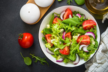 Green salad from leaves and tomatoes.