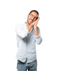 Fototapeta premium Relaxed young man making a gesture of sleep