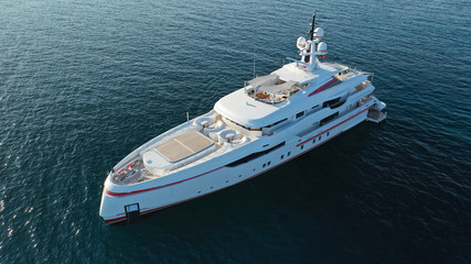 Fototapeta premium Aerial drone photo of luxury yacht docked in Mediterranean destination with deep blue sea at sunset
