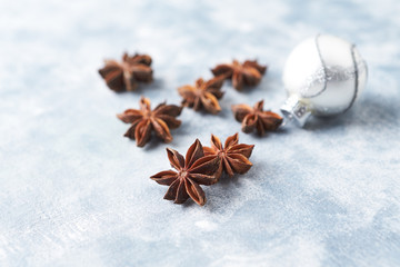 Christmas ball and Star anise on bright wooden background. Close up. Copy space. 
