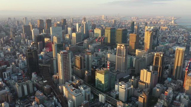 Aerial view over Osaka city with many skyscrapers in the morning. Osaka is the capital city of Osaka Prefecture, the second largest metropolitan area in Japan.