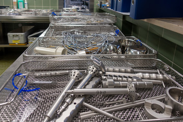 in a sterilization department in a hospital are many instrument trays that still need to be packed