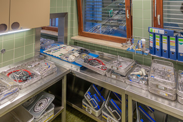 in a sterilization department in a hospital are many instrument trays that still need to be packed
