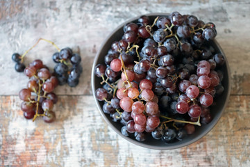 Selective focus. Fresh ripe grape. Blue and pink grapes. Autumn grape harvest.