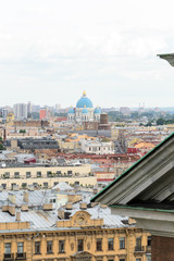 Fototapeta na wymiar Cityscape view of the city of Saint Petersburg, Russia. in the midst of many roofs emerge the colorful blue domes of the famous Trinity Cathedral