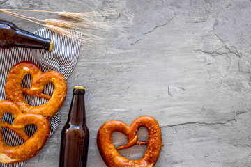 Octoberfest frame. Pretzels and beer on grey background top view copy space