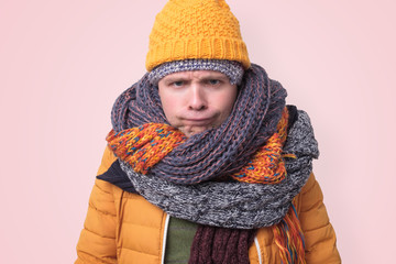 Handsome caucasian funny man in several hats and scarfs.