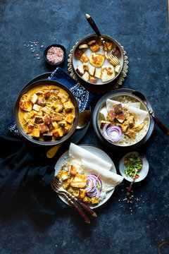 Indian Vegetarian Dinner - Shahi (Royal) Paneer Curry , Cumin Rice and Rice Flatbread with onion and green chiles.