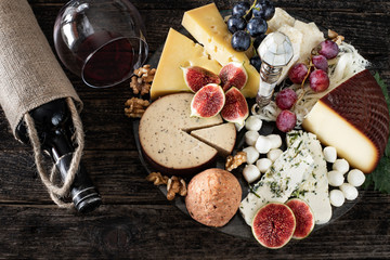 Red wine in the bottle and in the glass with appetizer