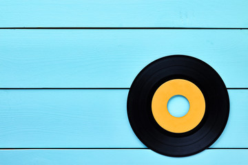 Vinyl record blue wooden table background