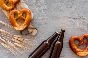 Octoberfest background. Pretzels and beer on grey background top view copy space