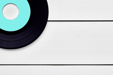 Vinyl record on white wooden background