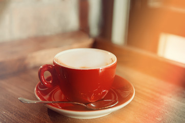 Cup of cappuccino coffee on wooden table