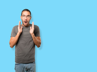 Fototapeta premium Astonished young man with a gesture of shock