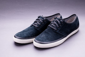 black trendy sneaker shoes on dark background.