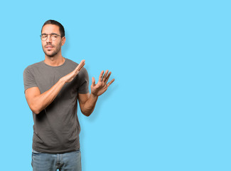 Haughty young man making a contemptuous gesture