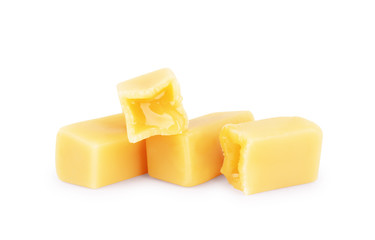 Caramel flows from candy on a white background