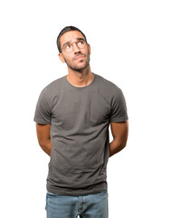 Concerned young man making a gesture of doubt