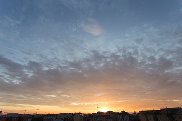 Colourful sunset over a dark city
