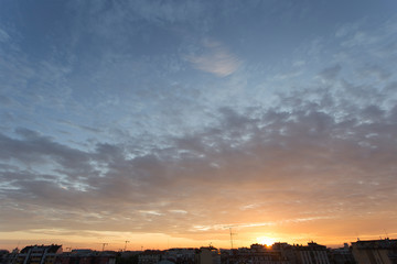 Colourful sunset over a dark city