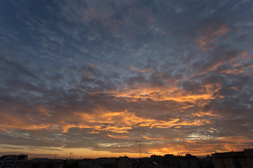 Colourful sunset over a dark city