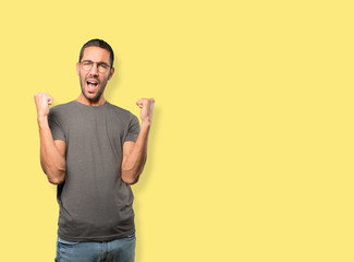 Competitive young man making a gesture of celebration