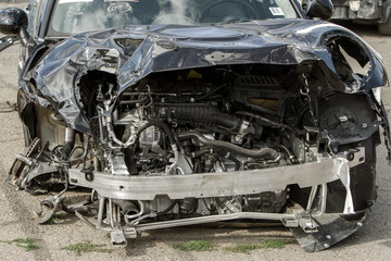 The body of the car is damaged as a result of an accident. High speed head on a car  traffic accident. Dents on the car body after a collision on the highway