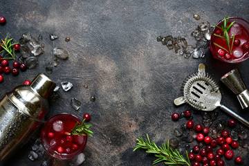 Winter christmas cocktail with cranberry and rosemary in a glasses. Top view with copy space.
