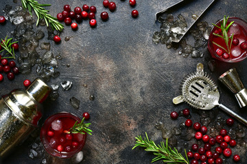 Winter christmas cocktail with cranberry and rosemary in a glasses. Top view with copy space.