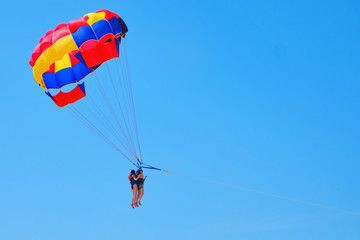 Tandem skydivers against the blue sky - two women in tandem