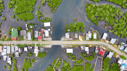 The village and the road on the water, view from above. Houses among the mangroves. Philippine village.