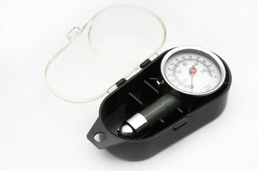 Pressure gauge for measuring air pressure in car tires on a white background