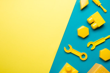 Colorful kids toys frame on wooden background. Top view. Flat lay. Copy space for text.