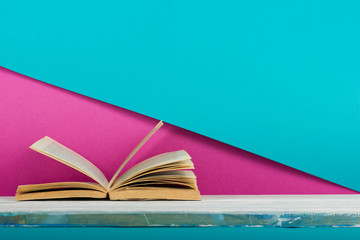 Open book, hardback books on wooden table. Back to school. Copy space