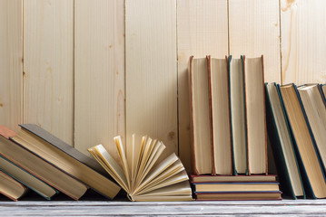 Open book, hardback books on wooden table. Back to school. Copy space