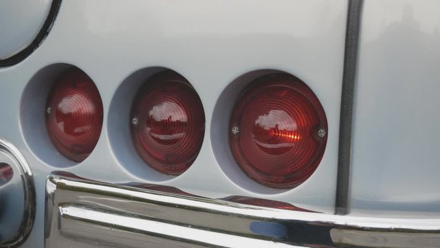 flashing taillights of a vintage light blue retro car