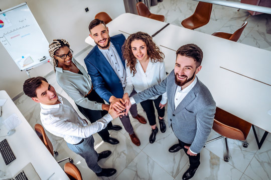 Teamwork. Young business people showing unity with their hands together. Business concept.View from above.