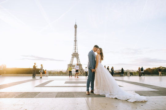 Happy romantic married couple hugging near the Eiffel tower in Paris