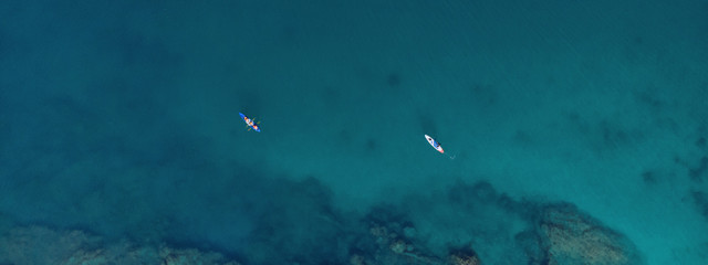 Obraz na płótnie Canvas Aerial view of a surfer in the ocean