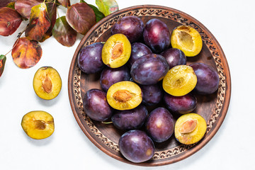 Fresh sweet ripe plums on the table top view. Fresh organic autumn dessert.