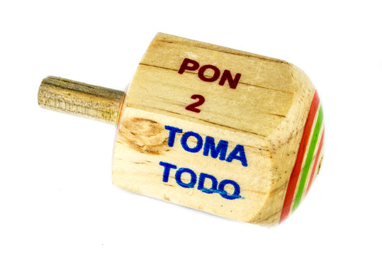 Traditional pirinola mexican handcrafted wooden toy with titles in spanish "take all, put one, put two, everyone puts"